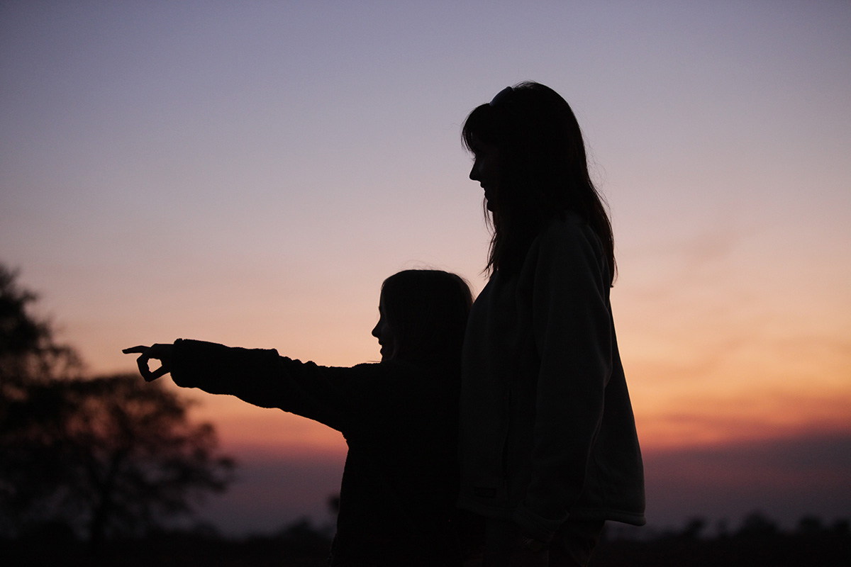 Jennifer and Amber silhouette on African plains