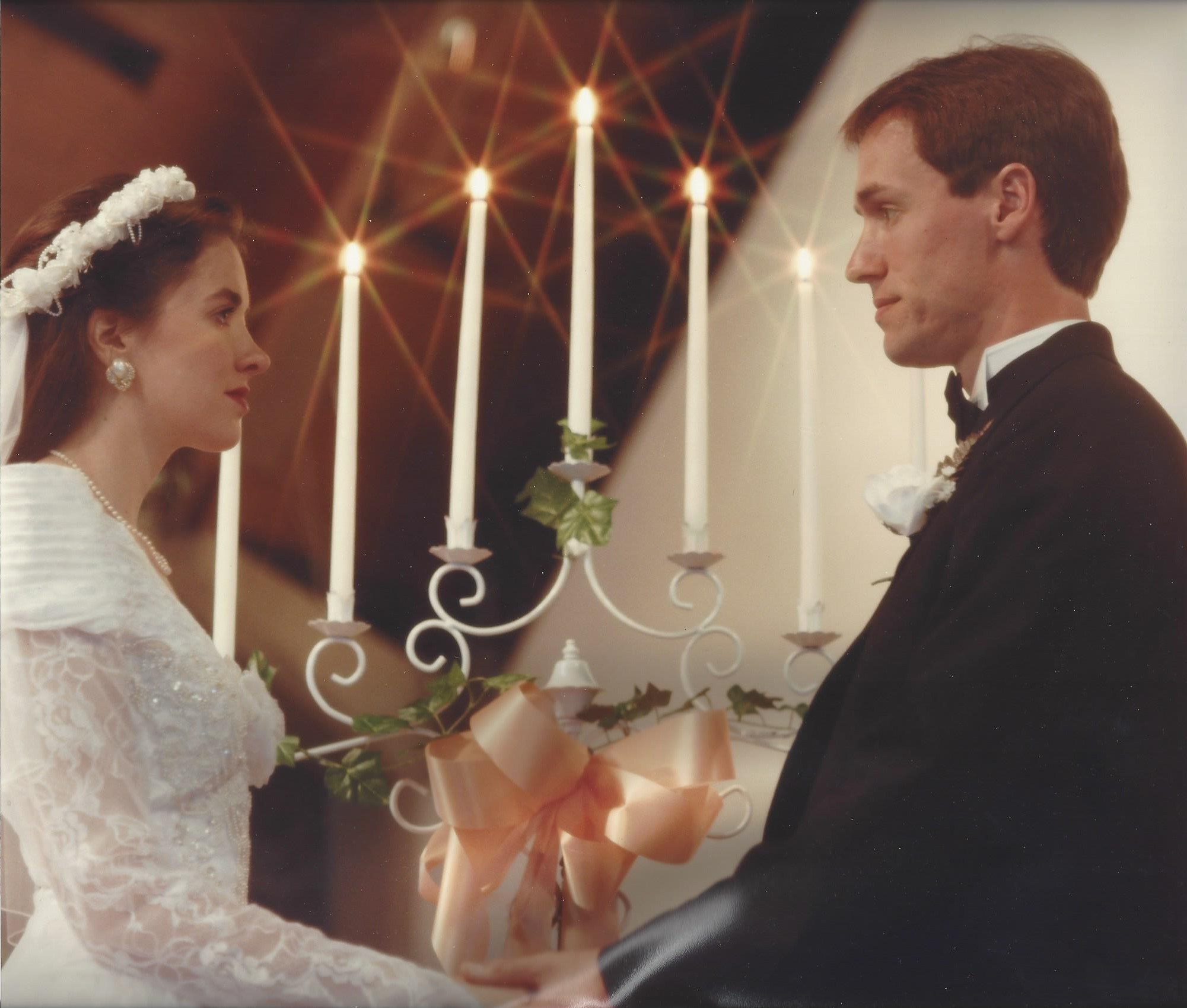 Wedding couple in front of candles