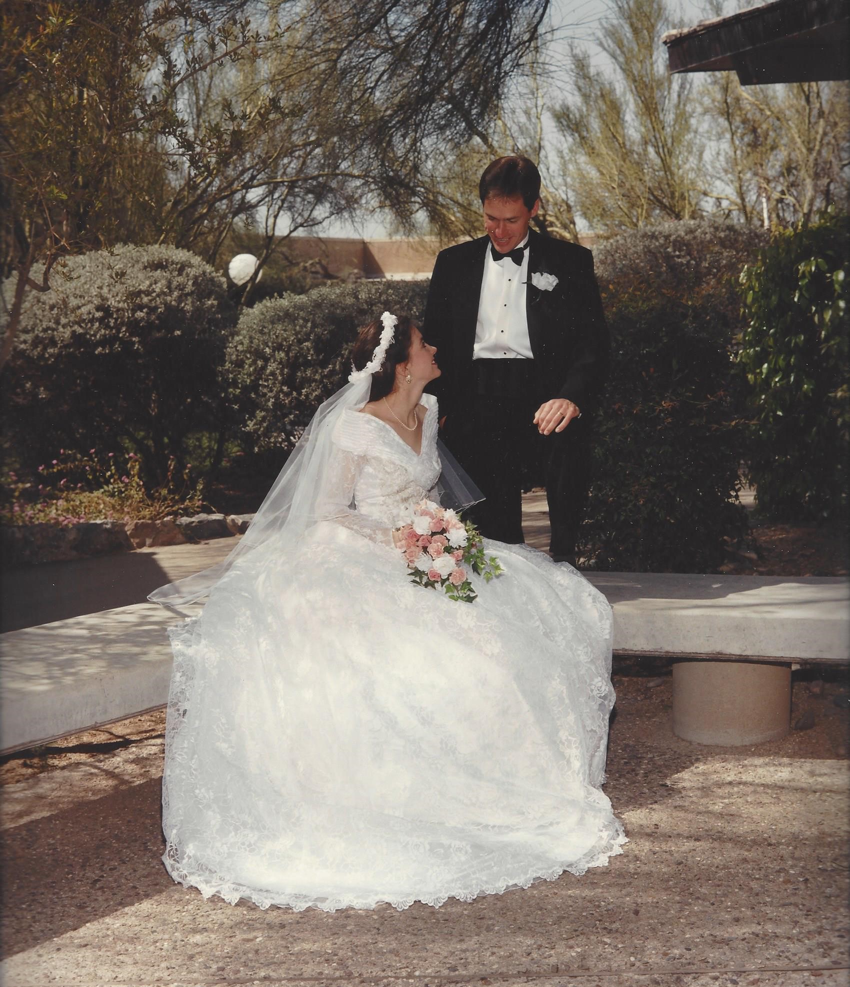 Wedding couple, bride seated and groom standing