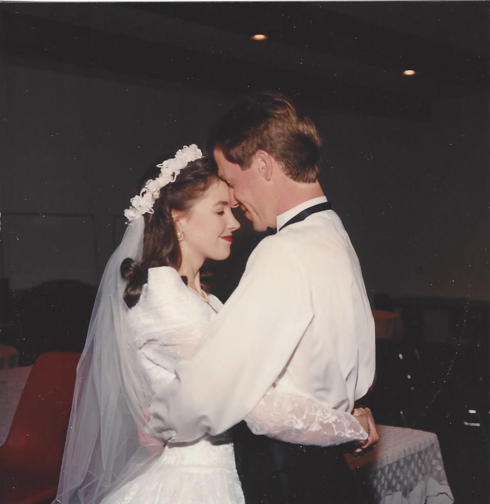 Bride and groom hugging at reception
